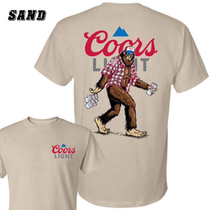 Coors Light Sasquatch T-shirt , Fun Bigfoot Design With Plaid Shirt And Coors Light Cans , Unisex Sand Tee , Perfect For Beer Lovers And Outdoor Enthusiasts , Comfortable And Stylish , Great For Casual Wear Classic Crewneck Menswear Streetwear Underwear